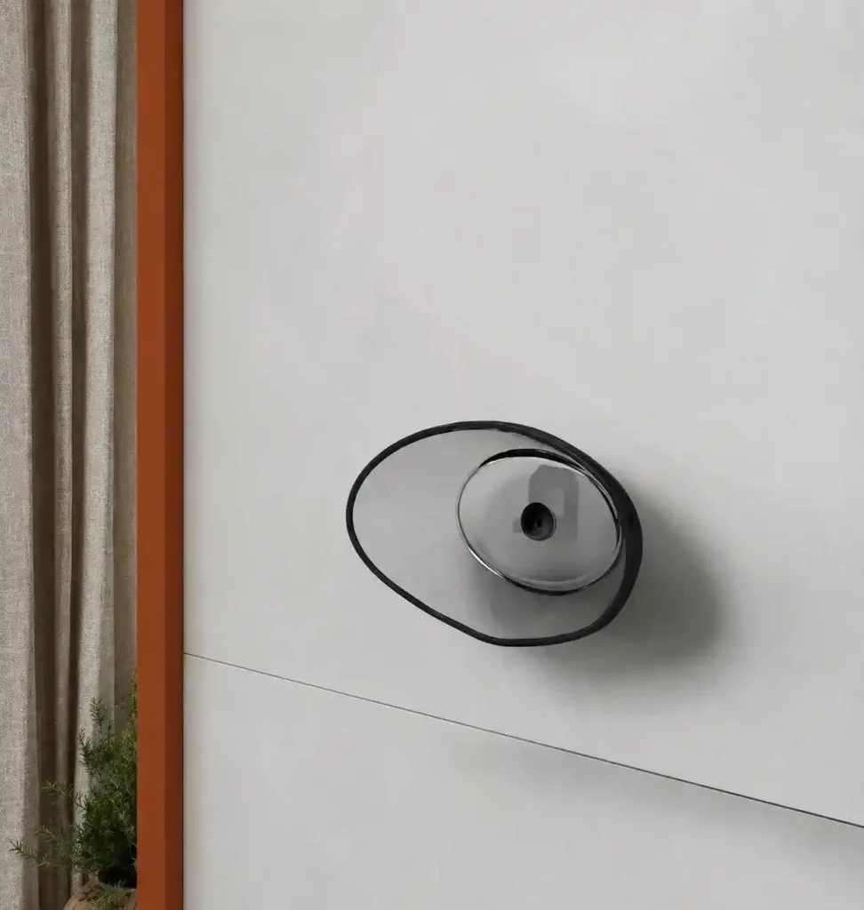 Modern wall-mounted faucet on a light stone tile surface.
